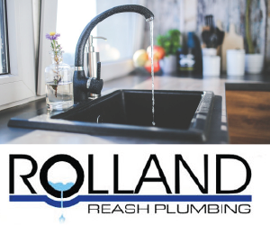 Sleek black kitchen sink with running water and modern faucet in a bright kitchen.