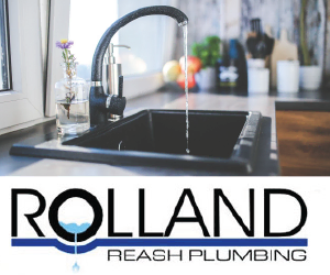 Sleek black kitchen sink with running water and modern faucet in a bright kitchen.